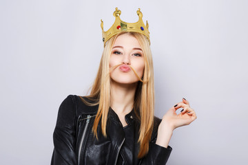 Gorgeous young girl wearing black jacket and crown