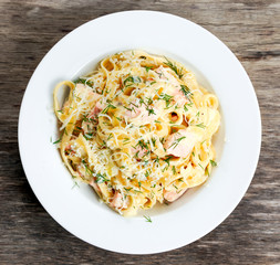 tasty pasta with salmon, dill on plate