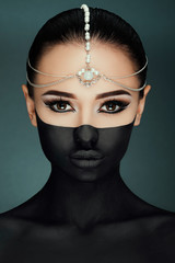 Beautiful young woman posing on the black background