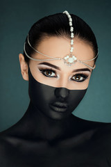 Gorgeous girl posing on the dark blue background