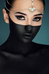 Sensitive woman looking at camera on the dark blue background