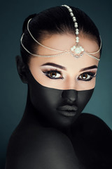 Gorgeous young girl posing on the dark blue background