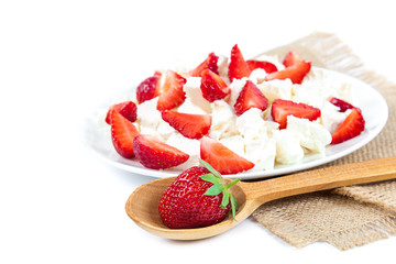 Fresh strawberries with cottage cheese and wooden spoon.