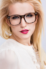 A portrait of beautiful blonde girl wearing glasses