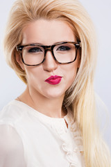 A portrait of beautiful blonde girl wearing glasses