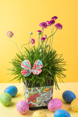 Easter table decoration with flower pot and eggs.