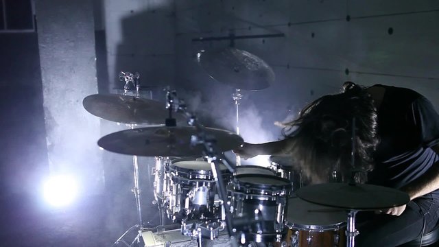 drummer playing drums, in the hangar