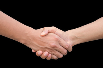 Closeup of two businessmen, lawyers or politicians shaking hands to celebrate a successful agreement with one of them holding the other hand in his pocket. Isolated over black background.