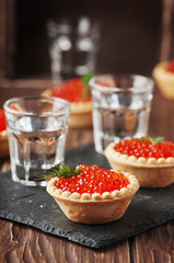 Traditional russian red caviare on the wooden table