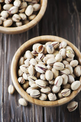 Salt pistachio nuts in the wooden bowl
