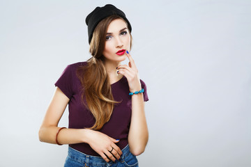 Cute girl with red lips wearing shirt at gray background