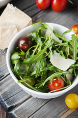 Healthy salad with rocket, tomato and parmesan cheese