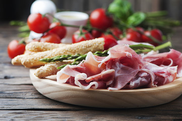 Antipasto with ham and green asparagus