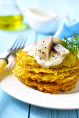 Potato fritters with herring.