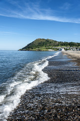 Shoreline of Irish seaside resort Bray Ireland with Bray Head mountain in the background