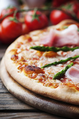 Italian pizza with ham and asparagus