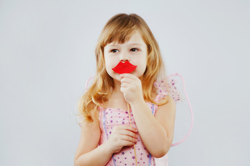 Little fairy posing with paper lips on white background