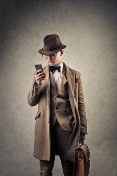 Elegant man checking his smartphone