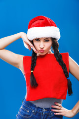 Beautiful young woman posing with red Christmas bag