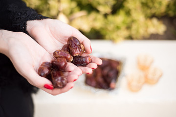 Middle Eastern Woman Offering Date Fruits for Ramadan