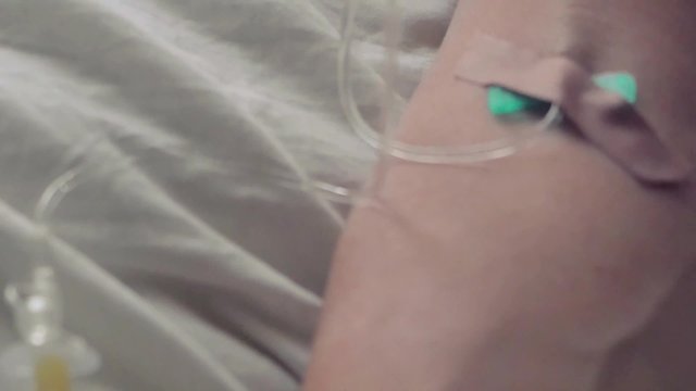 Hand of a patient with pulse meter lying with drop counter on the bed. 1920x1080