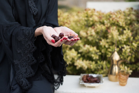 Middle Eastern Woman Offering Date Fruits for Ramadan