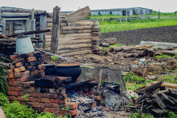  Abandoned ruined old house, hut. In the middle stands a stove. The fallen roof. 
