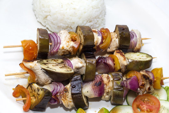 skewers of vegetables and chicken with rice and vegetables