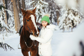 beautiful girl and horse in winter