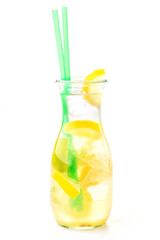 fresh tropical or summer lemonade with lemon, lime and ice in glass, beverage isolated on white background