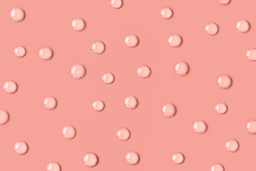 The pink drops of water on the table. The salmon color. Background.
