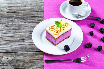piece of cake souffle with blackberries, cup of coffee, closeup