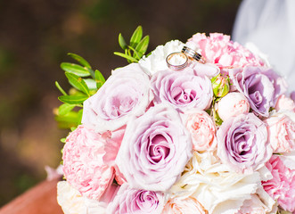 close-up of bride bouquet and wedding rings