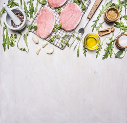 Ingredients for cooking pork with herbs and pepper border ,place for text  on wooden rustic background top view