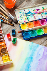 Naklejka premium Watercolor paints, brushes for painting and paper sheet of paint
