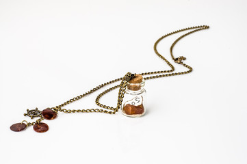Pendant made with glass bottle, antique gold chain and amber