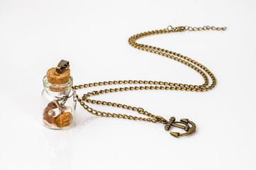 Pendant made with glass bottle, antique gold chain and amber