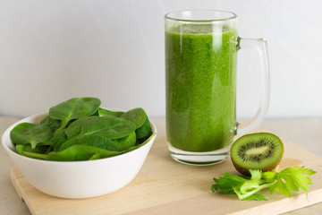 Healthy green smoothie made from spinach, celery and kiwi