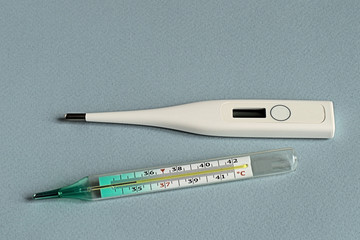   Thermometers.   Thermometers for measuring body temperature on a gray background.