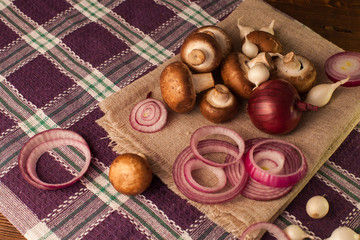 On napkin are cutted onion and mushrooms