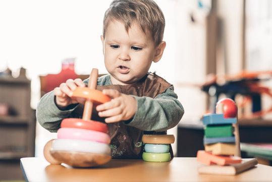 Caucasian boy playing with toy in preschool