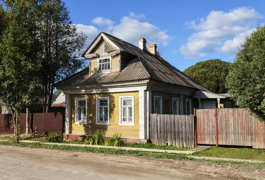 Old yellow wooden house in the country