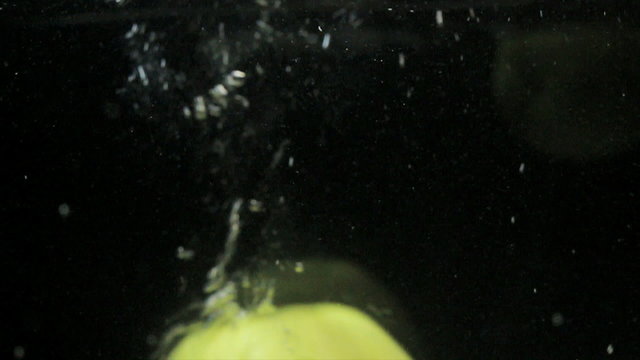 Big juiced fruits, macro Spins on dark background  