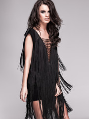 sexy slim woman model with long legs in black dress and high hee