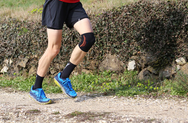 cross-country runner during the race with his knee wrapped by a