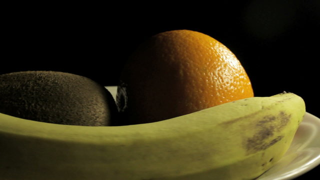 Big juiced fruits, macro Spins on dark background  