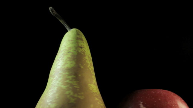 Big juiced fruits, macro Spins on dark background  