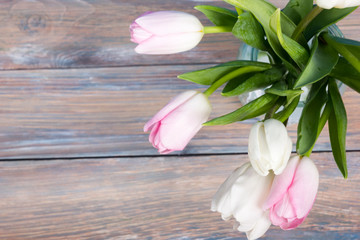 Obraz na płótnie Canvas Colorful tulips flowers on blue wooden desk table background. Copy space
