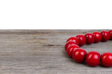 red wooden bracelet on wooden background