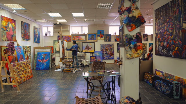 Senior painter holding a palette. creates in his studio